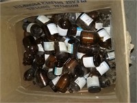 Box full of mini amber chemical bottles