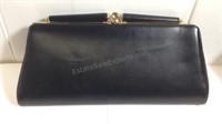 Black leather clutch with gold accents on clasp