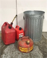 Galvanized trash can and three gas cans
