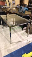 Modern chrome and glass dining table with an
