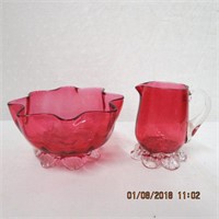 Cranberry glass footed creamer and sugar