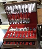 Vinyl silver box with flatware set on a wood