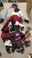 4 soft stuffed black dolls, and 4 molded plastic