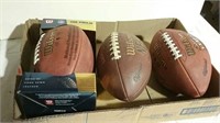 Three footballs