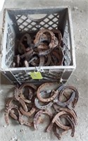 Crate full of horse shoes.