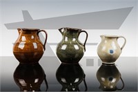 A set of 3 Jugtown pitcher vases