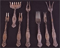 Seven sterling silver serving forks