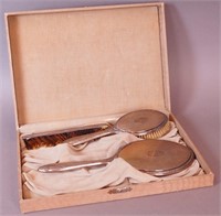 A silver mirror and brush set marked