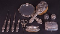 A group of silver vanity items marked