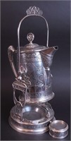 A silverplate insulated tilting pitcher marked