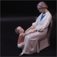 A B&G 9" high figurine of seated woman with boy