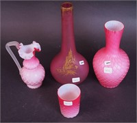Four pieces of pink glass including