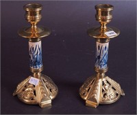 A pair of brass and porcelain candlesticks