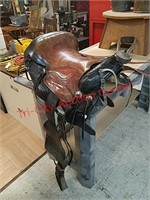 > Child's leather horse riding saddle