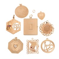 An Assortment of Gold Monogrammed Disc Charms