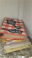 Dishes and cookbooks in the bottom shelves of