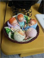 5 bisque babies in a basket in crochet outfits,
