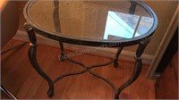 Glass rought iron table 24 1/2 inches wide 18 1/2