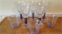 8 glasses, 5 stemmed wine glasses with purple