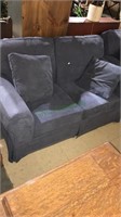 Overstuffed love seat with a navy blue fabric