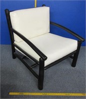 heavy black wooden chair with cushions