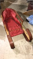 Wooden snow sled for a toddler with a cushion