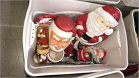Tote with lid full of vintage Santa clauses and