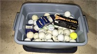 Small tub with golf balls some are new and has the