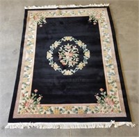 Large black and floral area rug