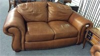 BROWN LEATHER LOVE SEAT WITH NAILHEAD TRIM