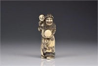 JAPANESE IVORY NETSUKE OF A FOREIGNER AND BOY