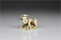 JAPANESE IVORY AND INLAY OKIMONO OF A YOUNG BOY