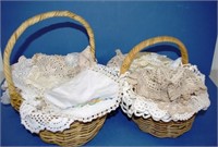 Two cane baskets of vintage table linen