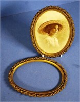 Two antique gilt metal oval frames