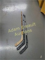 Three Wooden hockey sticks