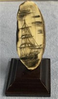 Fossilized walrus tooth scrimmed with sailing vess