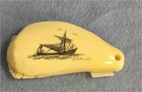 Scrimshawed tooth by Wilbur Willock an umiak with