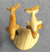 Group of 2 fossilized ivory and 1 white whale by F