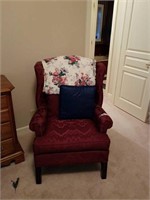 Burgundy wing back chair with cushion and pillow