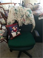 Green rolling office chair with quilt, pillow,
