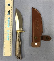A 9" buck knife, with a 4" blade, made in Pakistan