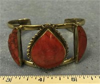 Woman's gold tone bangle bracelet with coral inset