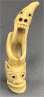 Ivory tupilak carved from whale's tooth: 5" tall