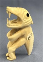 Ivory tupilak carved from whale's tooth: 4.25" lon