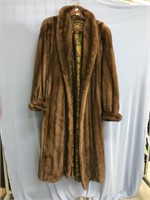 A woman's calf length brown mink fur coat, from th