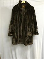 A woman's thigh length black mink fur coat. From t