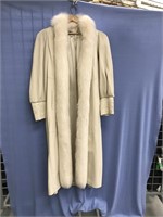 A woman's white leather, full length coat, with wh