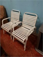 Two white outside chairs