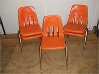 5 Orange Stackable Plastic Chairs