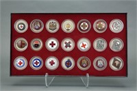 40 medals/lapel pins, mostly Red Cross.